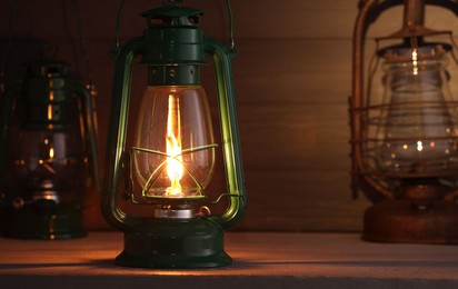 Photo of Vintage kerosene metal lamps on wooden table