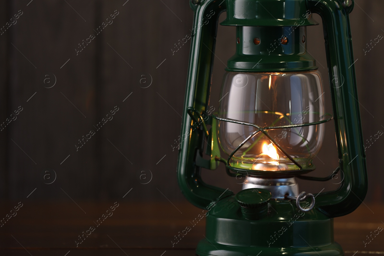 Vintage kerosene lamp on wooden table, closeup. Space for text Photo of Vintage kerosene lamp on wooden table, closeup. Space for text