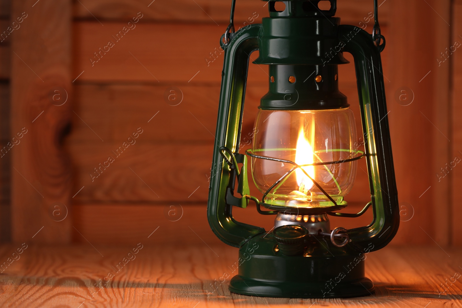 Vintage kerosene lamp on wooden table, closeup. Space for text Photo of Vintage kerosene lamp on wooden table, closeup. Space for text