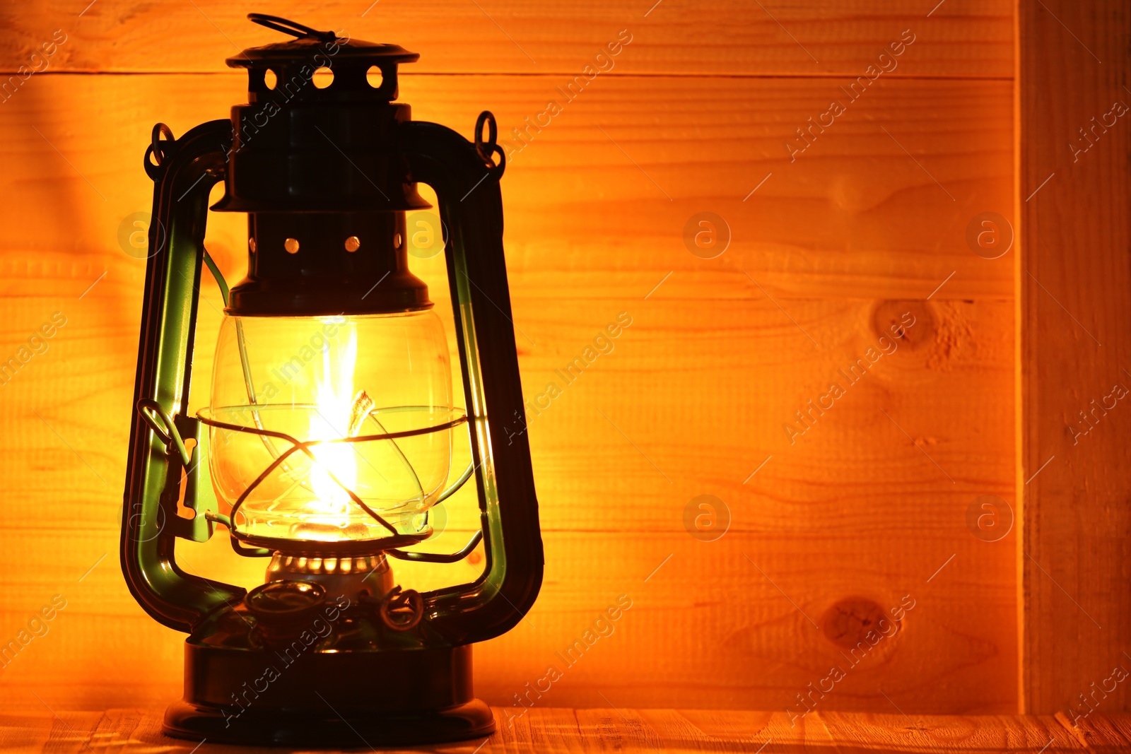 Vintage kerosene lamp on wooden table, closeup. Space for text Photo of Vintage kerosene lamp on wooden table, closeup. Space for text