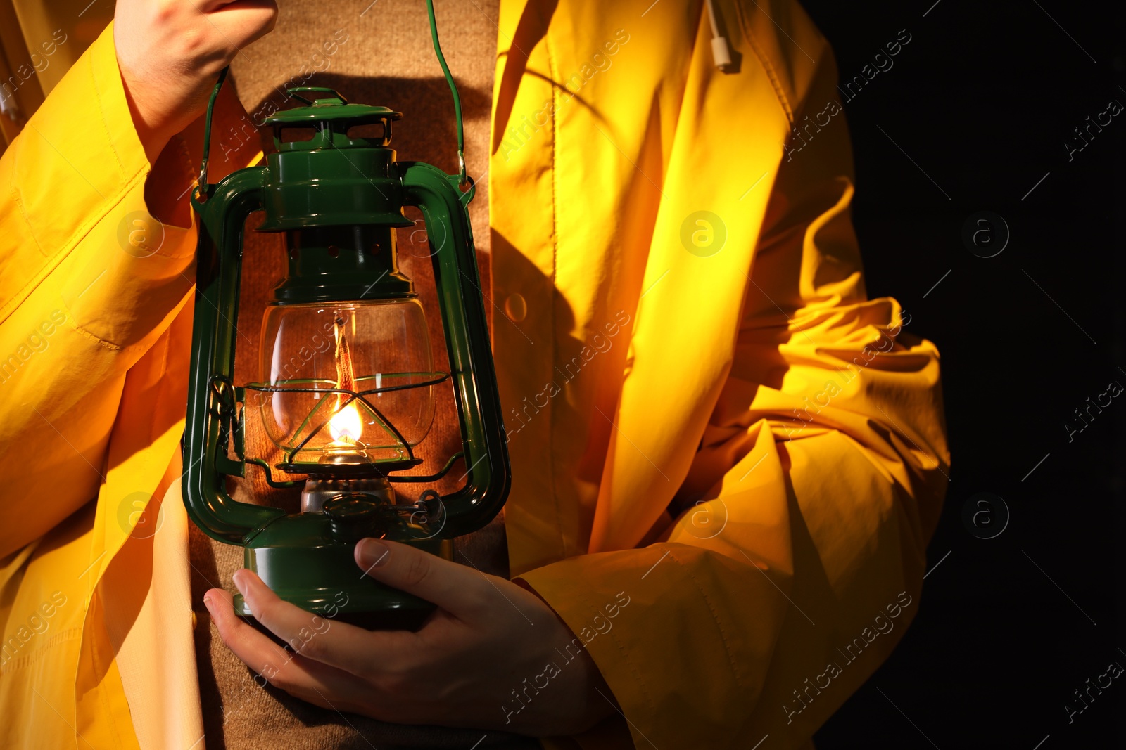 Man with vintage kerosene lamp on wooden background, closeup Photo of Man with vintage kerosene lamp on wooden background, closeup