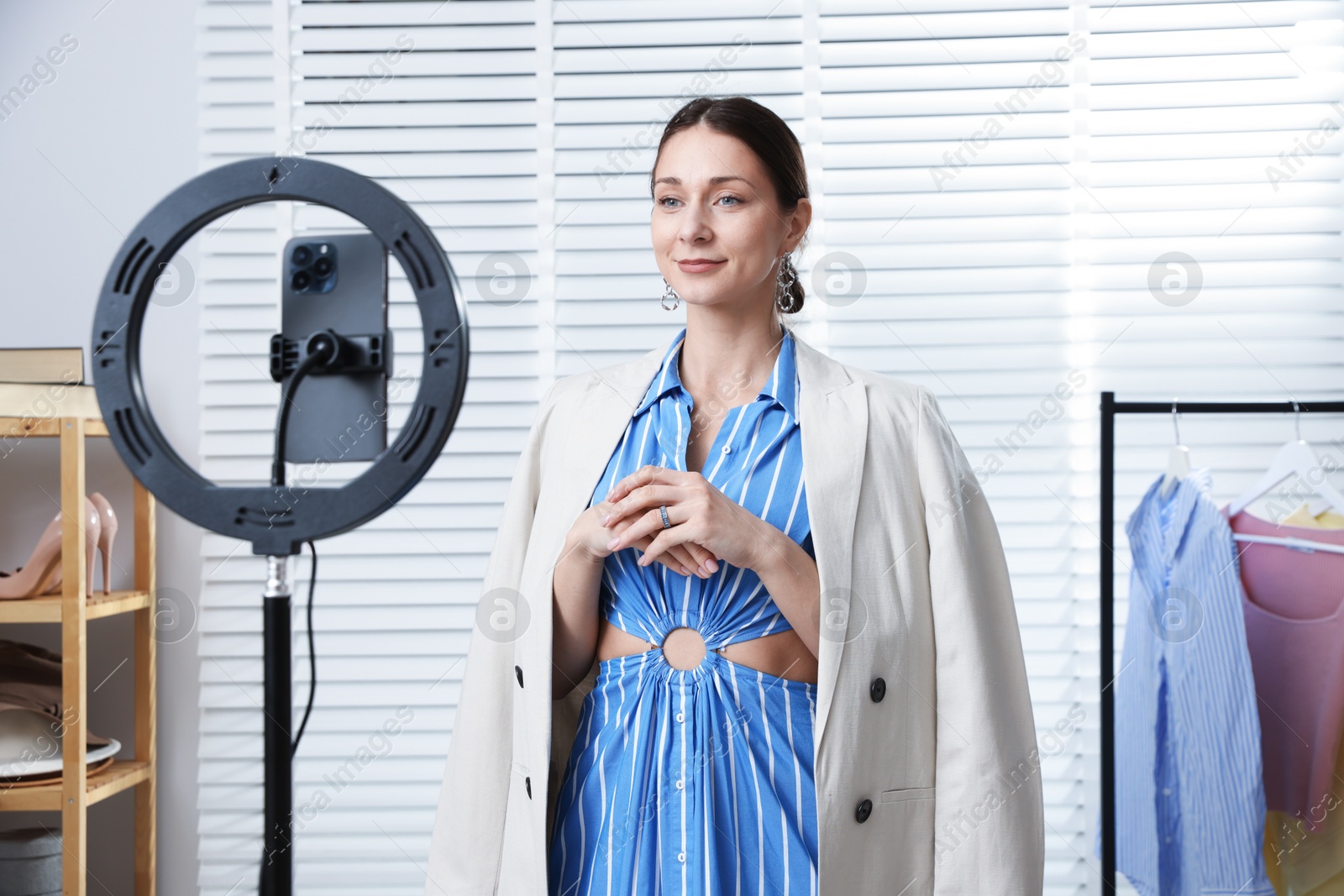 Professional stylist having online consultation with client via smartphone indoors Photo of Professional stylist having online consultation with client via smartphone indoors