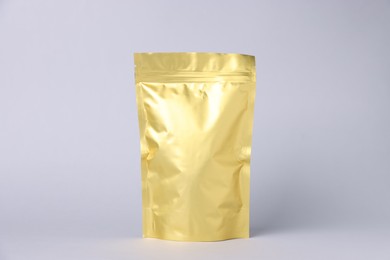 Photo of One zipper stand-up pouch on light grey background. Mockup for design