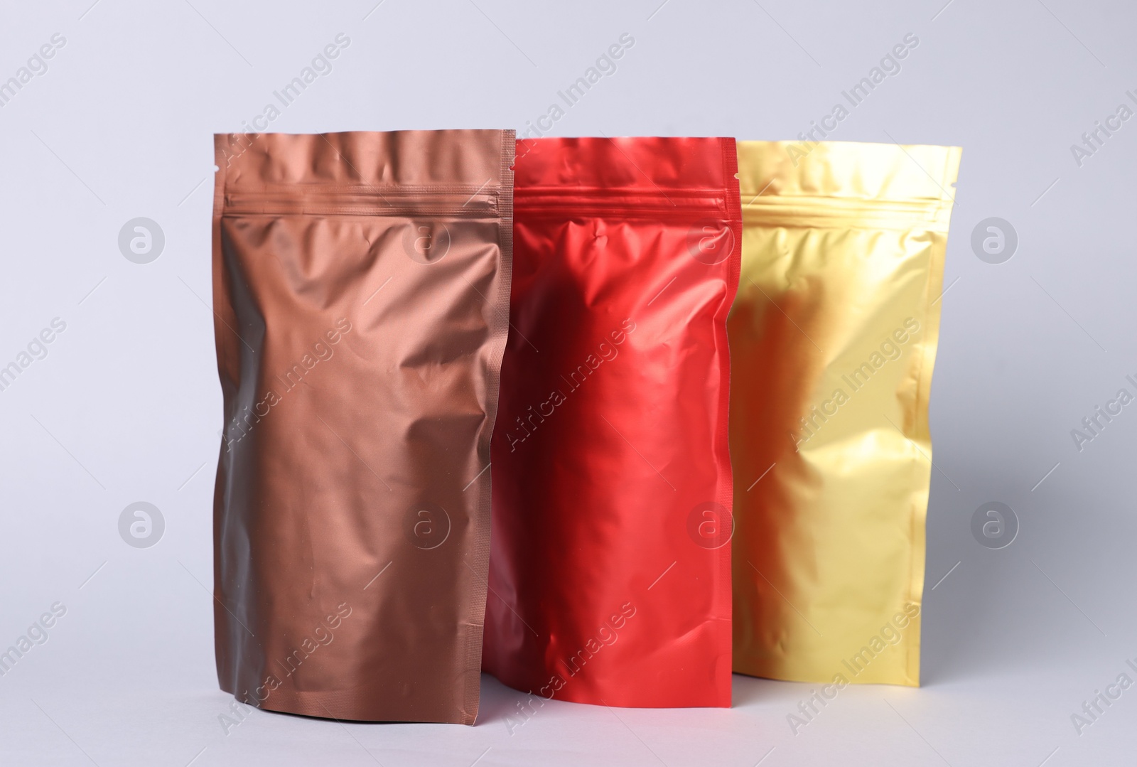 Zipper stand-up pouches on light grey background. Mockup for design Photo of Zipper stand-up pouches on light grey background. Mockup for design