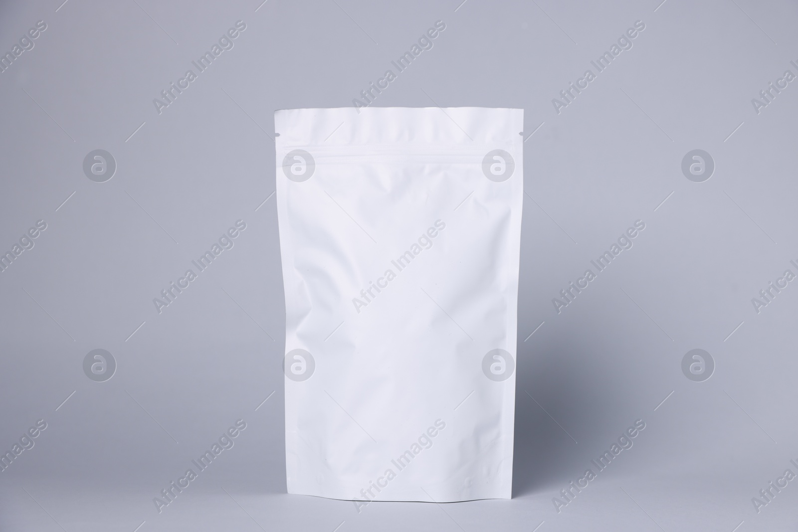 One zipper stand-up pouch on light grey background. Mockup for design Photo of One zipper stand-up pouch on light grey background. Mockup for design