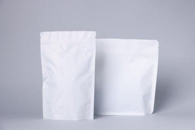 Photo of Zipper stand-up pouches on light grey background. Mockup for design
