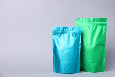 Photo of Zipper stand-up pouches on light grey background. Mockup for design