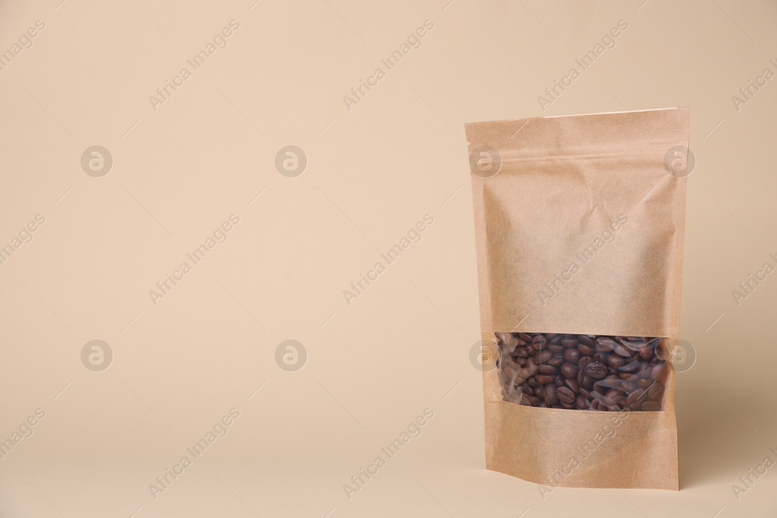 One zipper stand-up pouch with coffee beans on beige background. Mockup for design Photo of One zipper stand-up pouch with coffee beans on beige background. Mockup for design