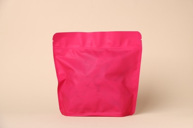 Photo of One zipper stand-up pouch on beige background. Mockup for design