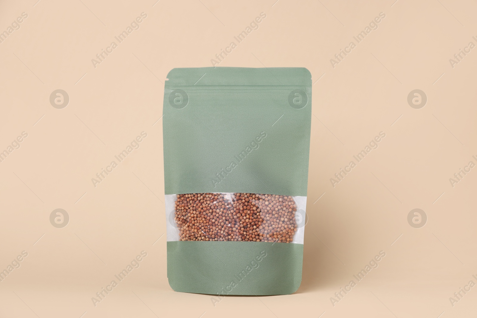 One zipper stand-up pouch with seeds on beige background. Mockup for design Photo of One zipper stand-up pouch with seeds on beige background. Mockup for design