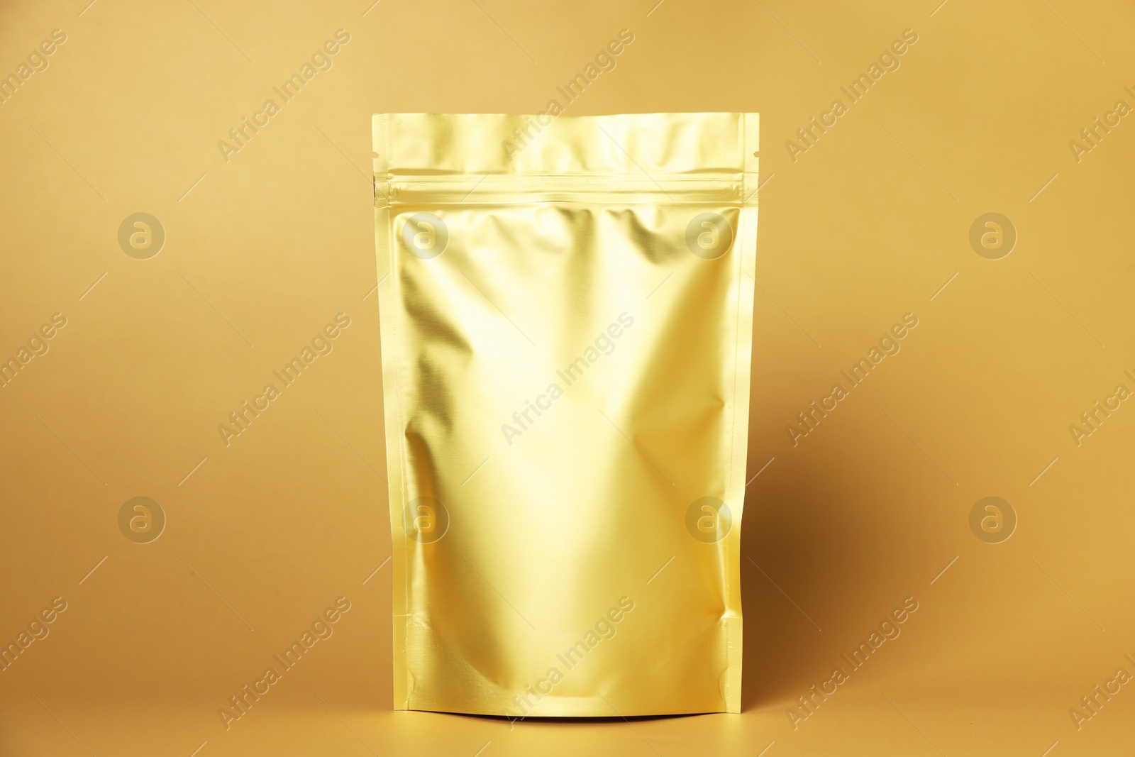 One zipper stand-up pouch on light orange background. Mockup for design Photo of One zipper stand-up pouch on light orange background. Mockup for design