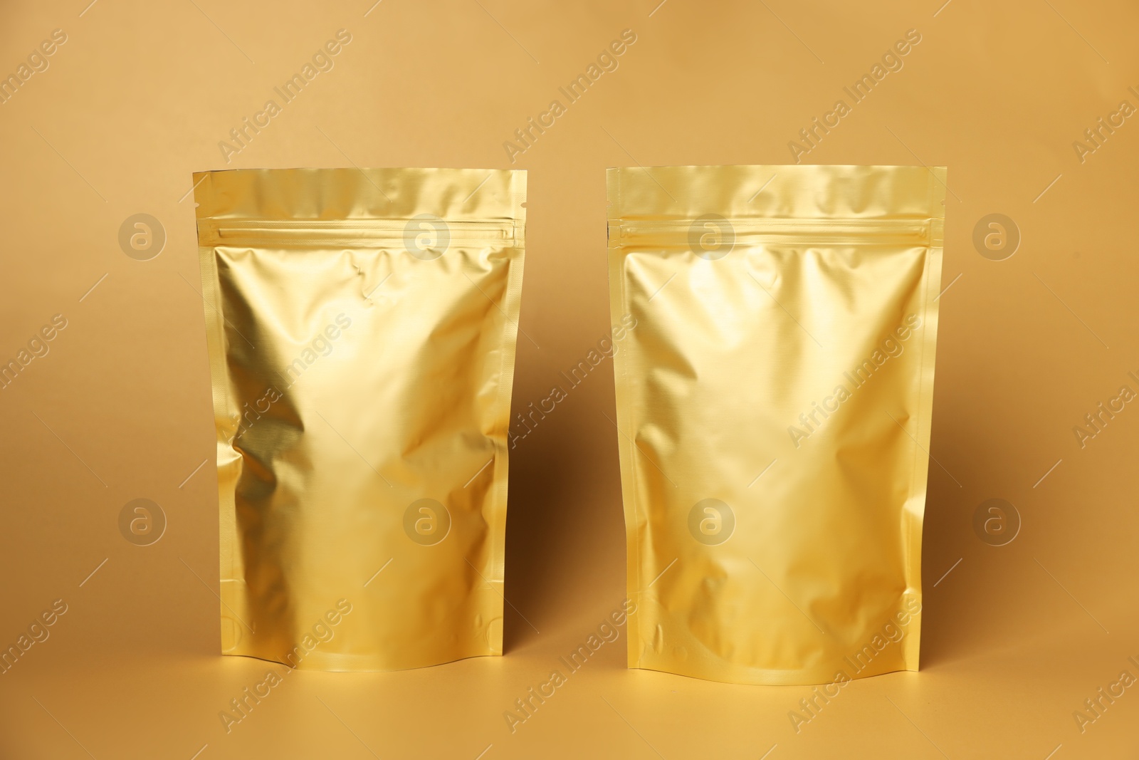 Zipper stand-up pouches on light orange background. Mockup for design Photo of Zipper stand-up pouches on light orange background. Mockup for design