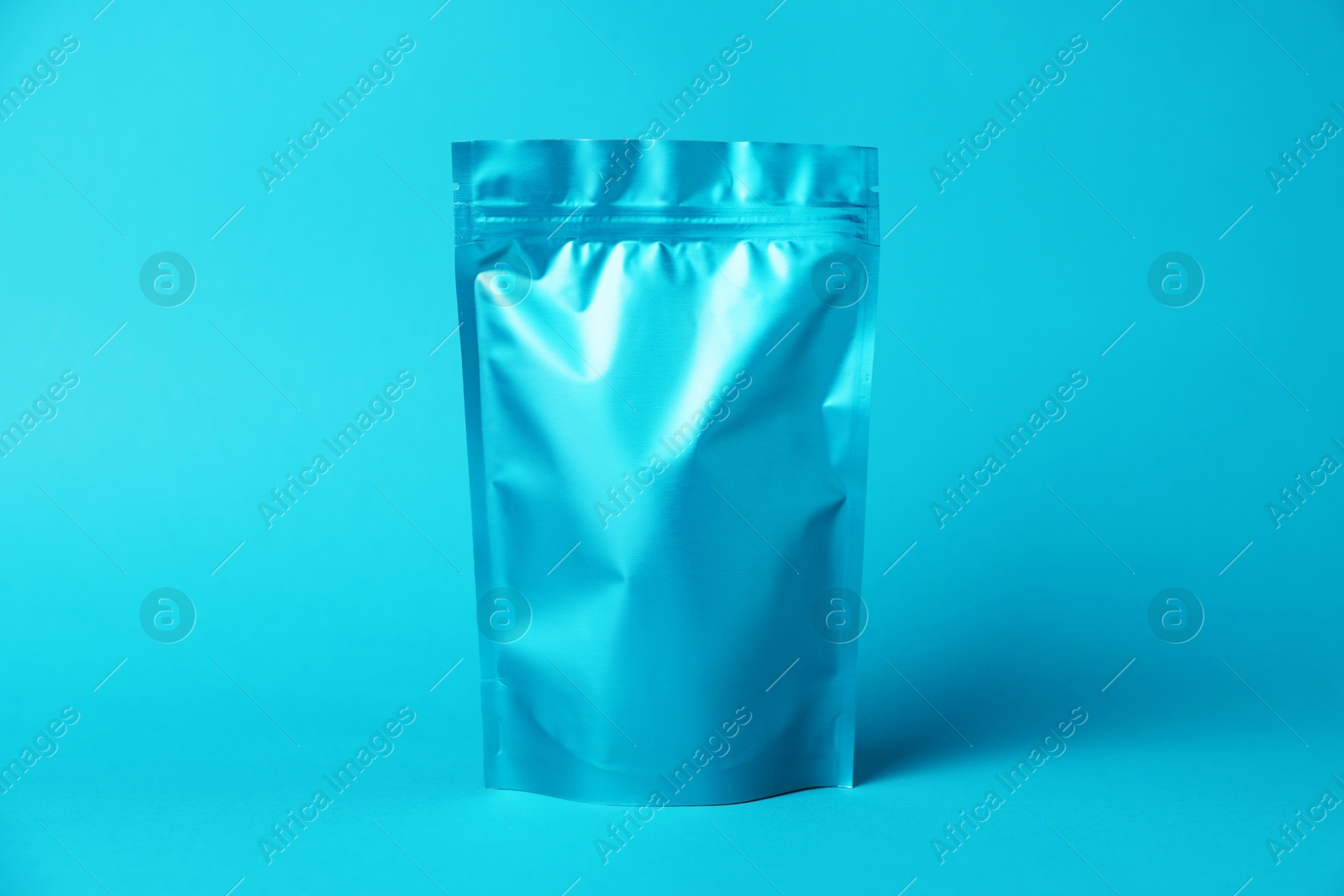 One zipper stand-up pouch on light blue background. Mockup for design Photo of One zipper stand-up pouch on light blue background. Mockup for design
