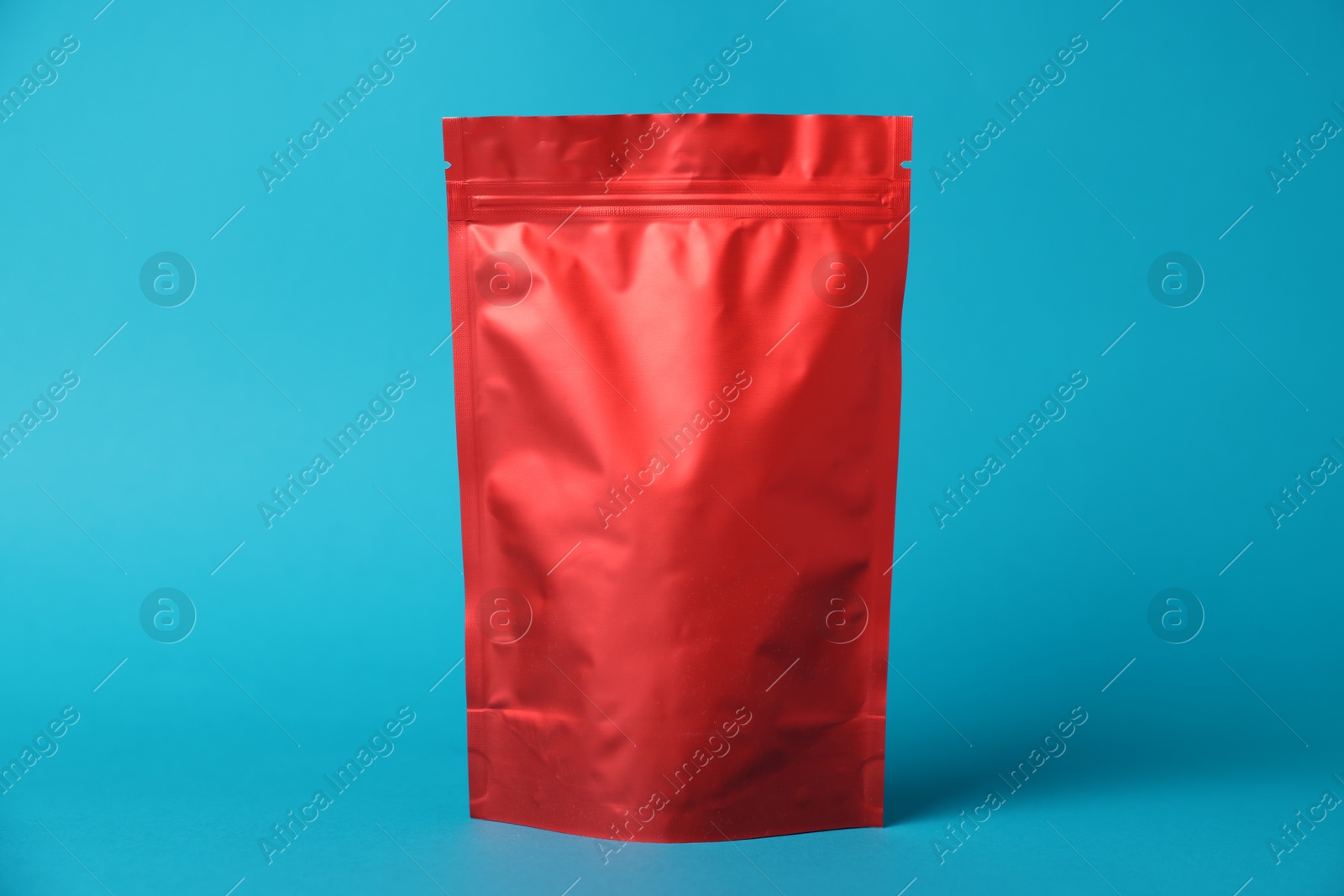 One zipper stand-up pouch on light blue background. Mockup for design Photo of One zipper stand-up pouch on light blue background. Mockup for design