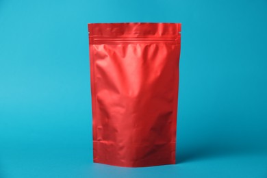 Photo of One zipper stand-up pouch on light blue background. Mockup for design