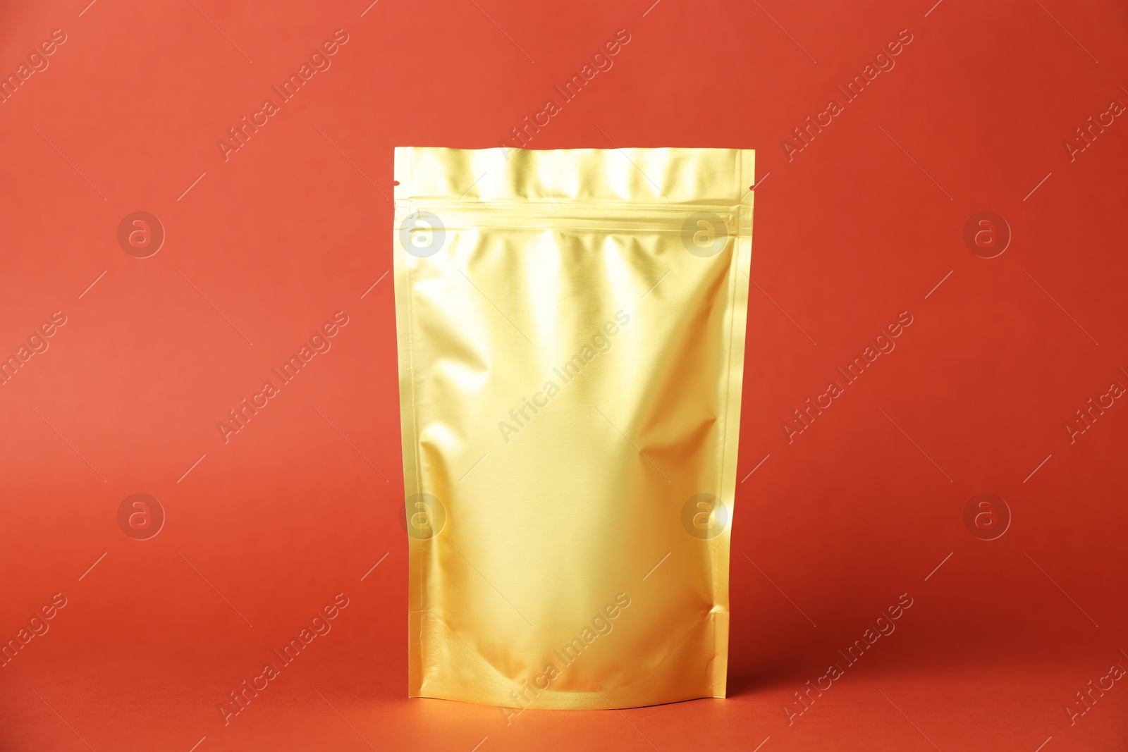 Photo of One zipper stand-up pouch on red background. Mockup for design
