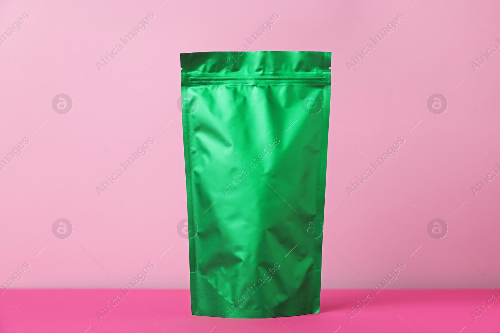 One zipper stand-up pouch on pink background. Mockup for design Photo of One zipper stand-up pouch on pink background. Mockup for design