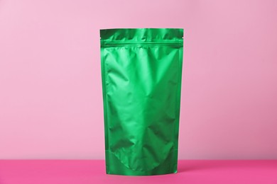Photo of One zipper stand-up pouch on pink background. Mockup for design