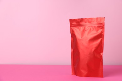 Photo of One zipper stand-up pouch on pink background. Mockup for design
