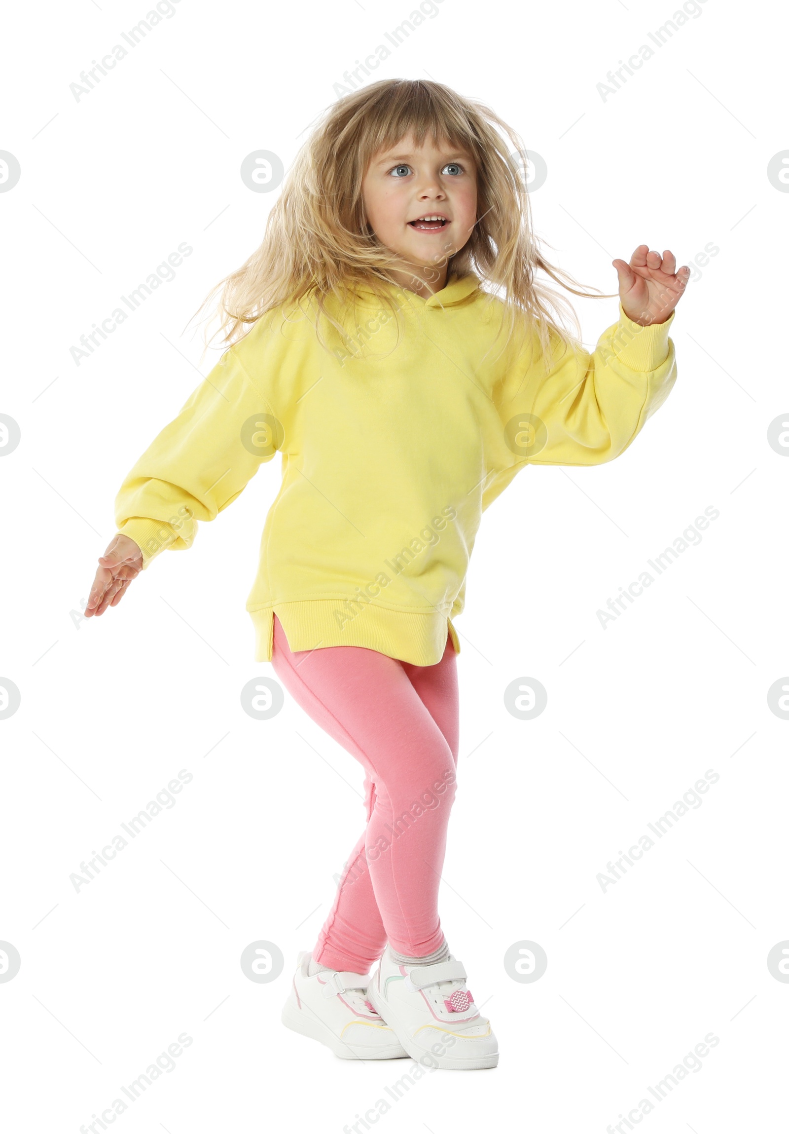 Cute little girl dancing on white background Photo of Cute little girl dancing on white background