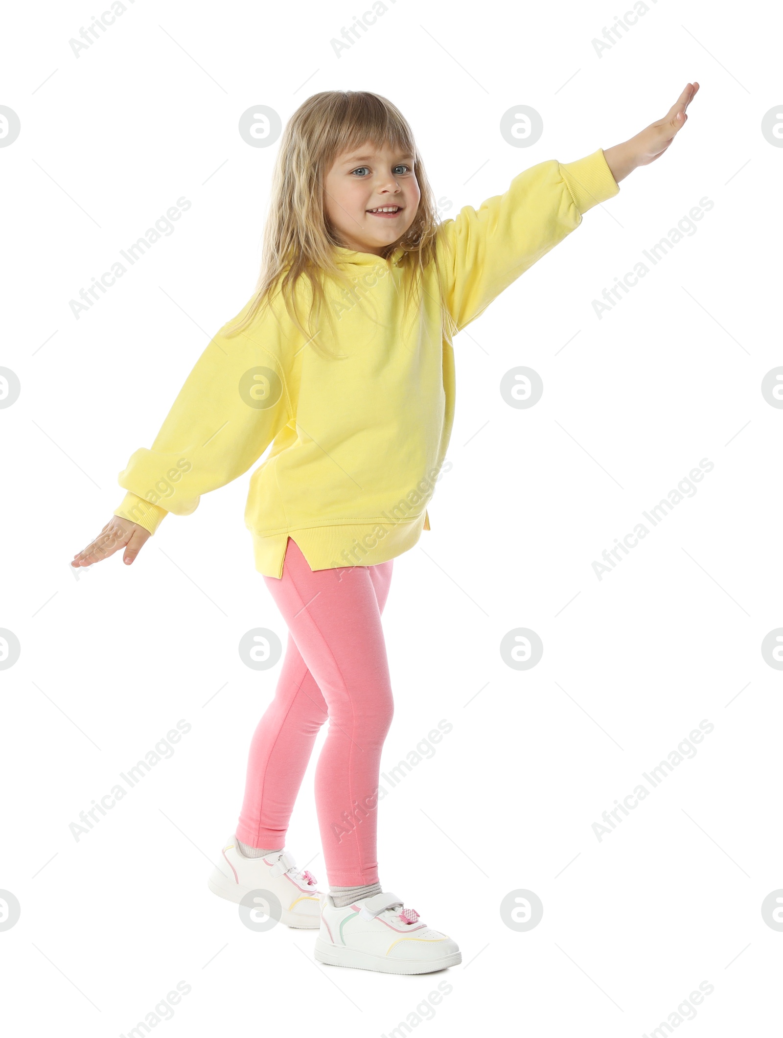 Happy little girl dancing on white background Photo of Happy little girl dancing on white background