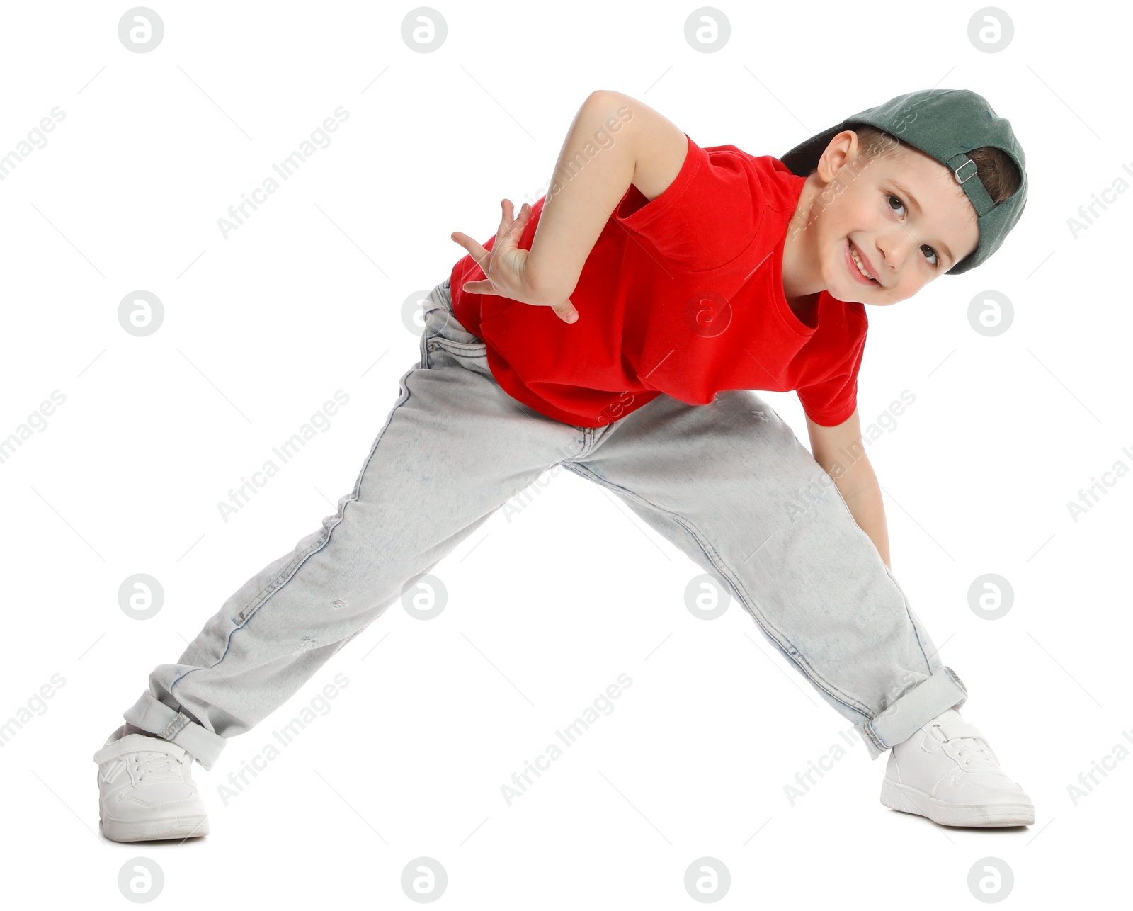 Happy little boy in baseball hat dancing on white background Photo of Happy little boy in baseball hat dancing on white background