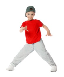 Photo of Cute little boy in baseball hat dancing on white background