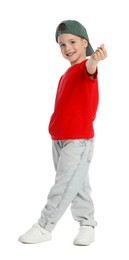 Photo of Happy little boy in baseball hat dancing and showing heart gesture on white background