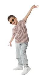 Photo of Happy little boy in sunglasses dancing on white background