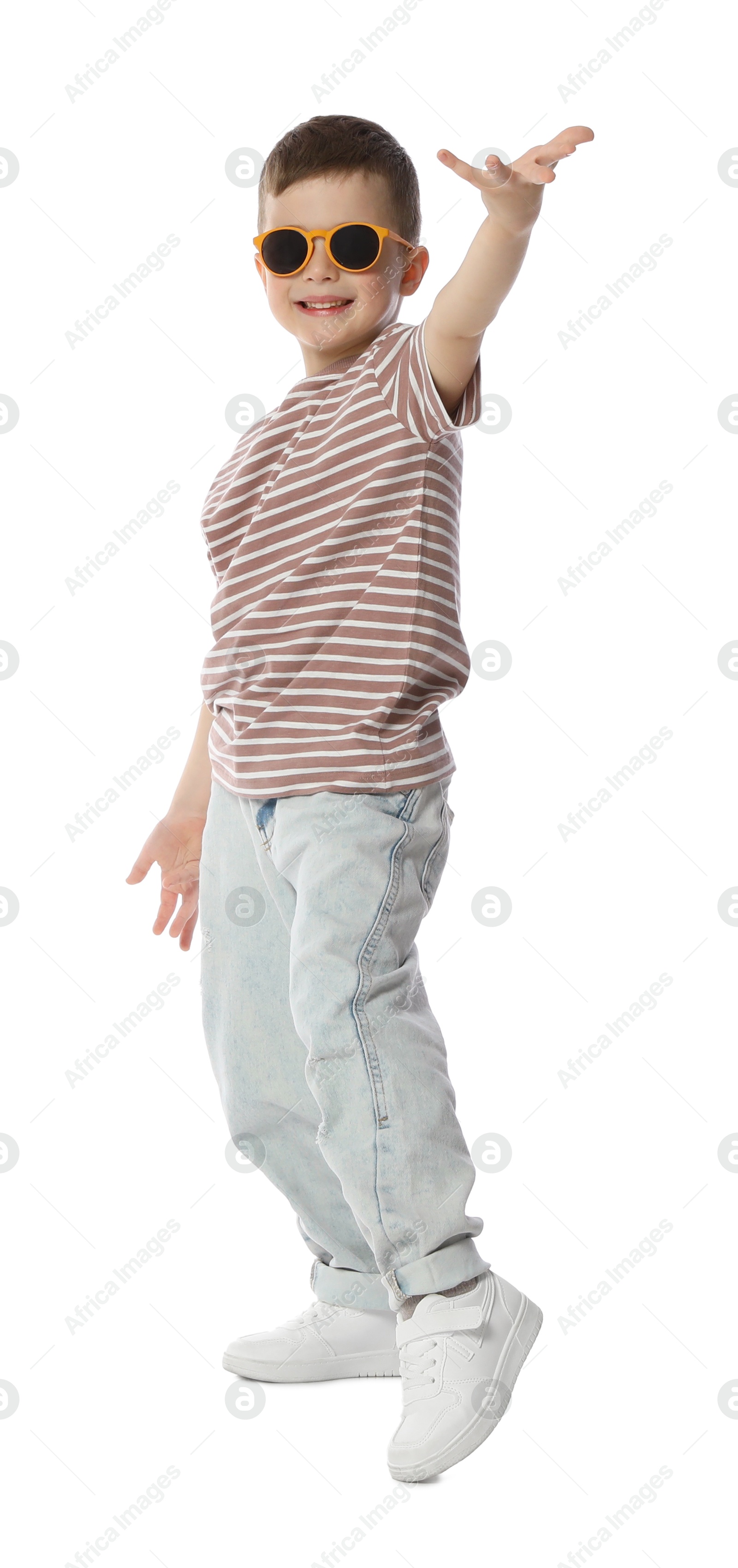 Happy little boy in sunglasses dancing on white background Photo of Happy little boy in sunglasses dancing on white background