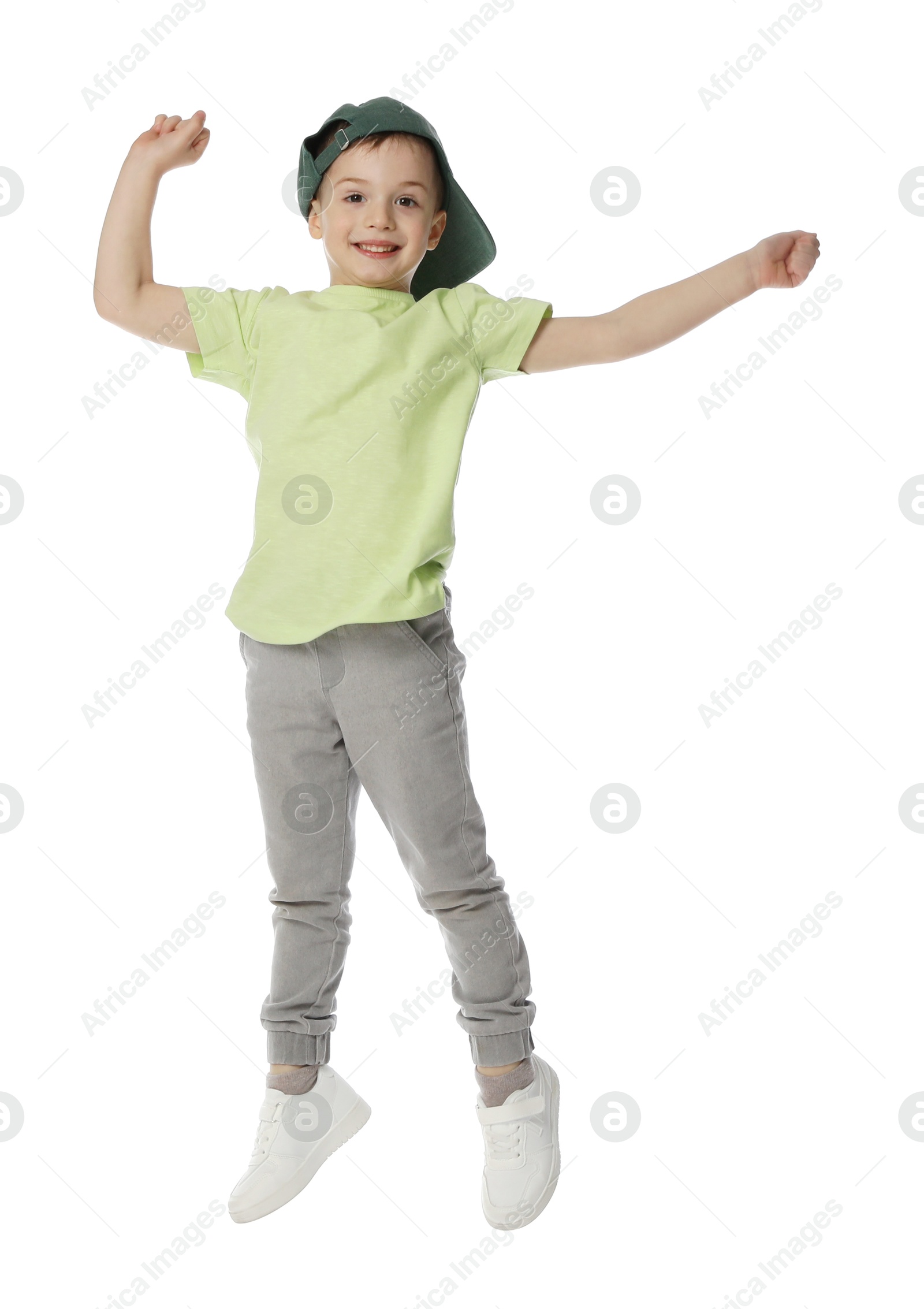 Happy little boy in baseball hat dancing on white background Photo of Happy little boy in baseball hat dancing on white background
