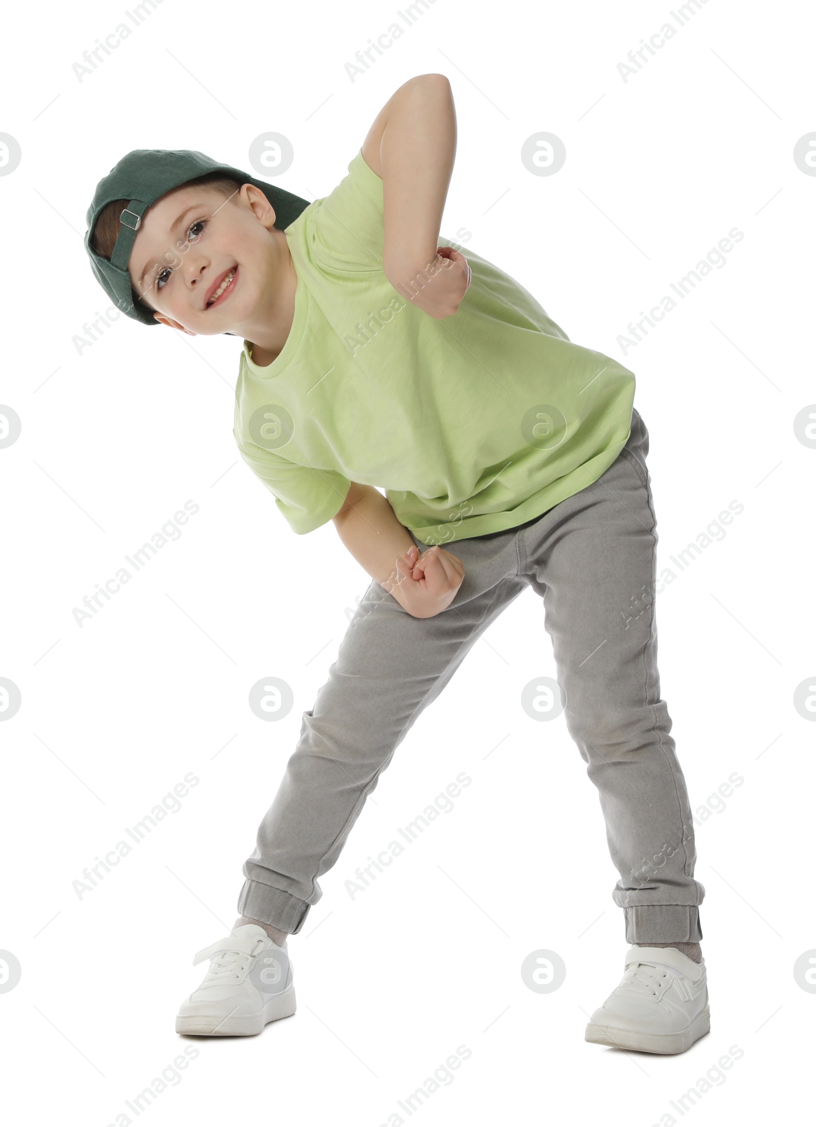 Happy little boy in baseball hat dancing on white background Photo of Happy little boy in baseball hat dancing on white background