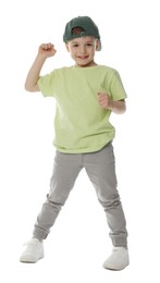 Photo of Happy little boy in baseball hat dancing on white background