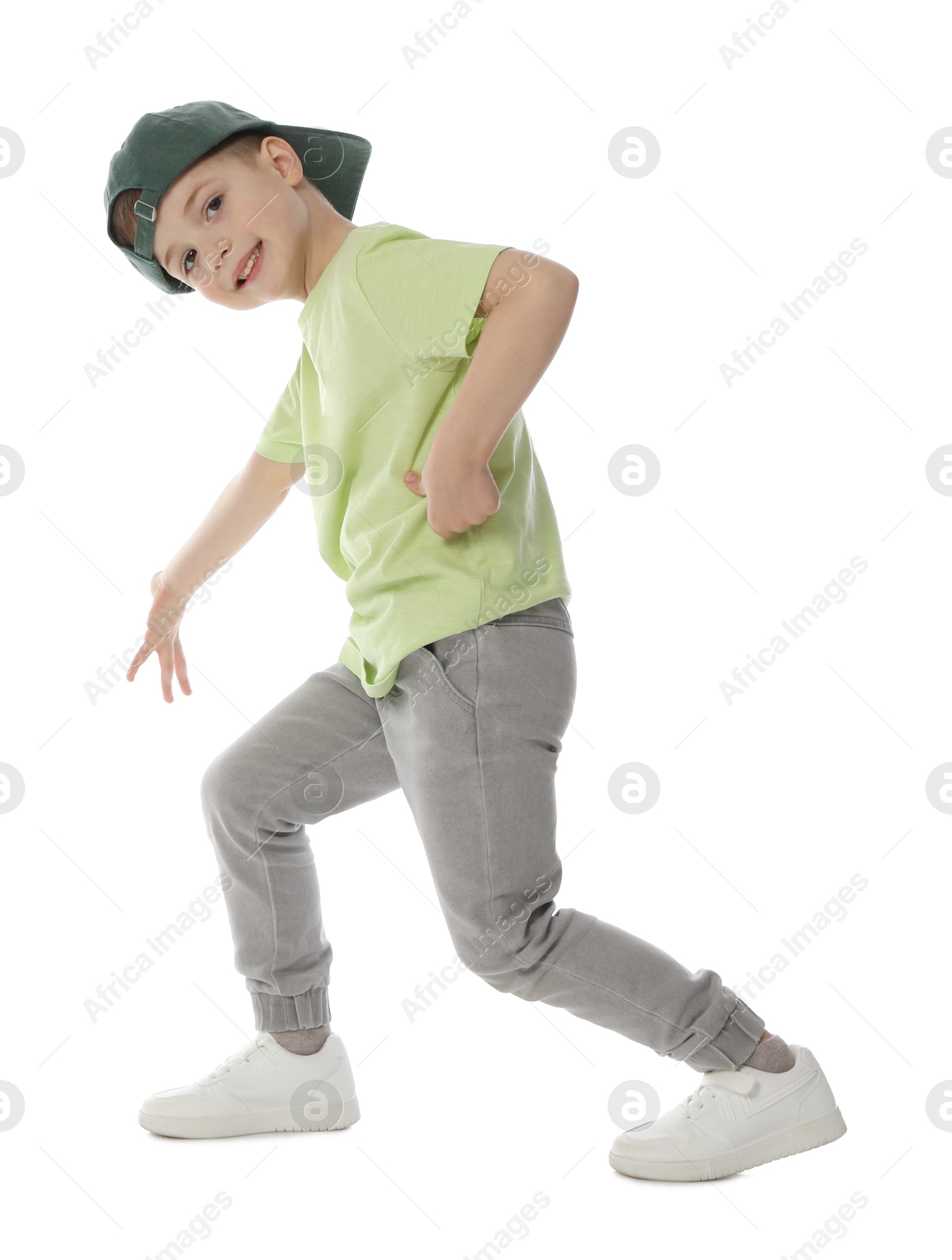 Happy little boy in baseball hat dancing on white background Photo of Happy little boy in baseball hat dancing on white background