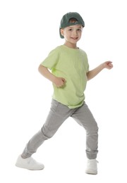Photo of Happy little boy in baseball hat dancing on white background