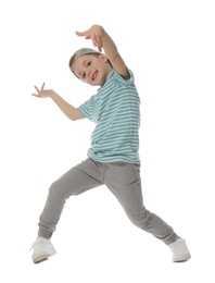 Photo of Happy little boy in baseball hat dancing on white background