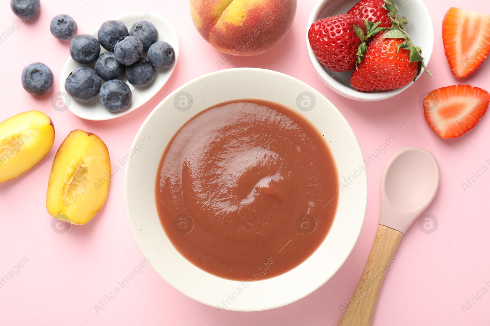 Baby food. Tasty puree in bowl and ingredients on pink background, flat lay Photo of Baby food. Tasty puree in bowl and ingredients on pink background, flat lay