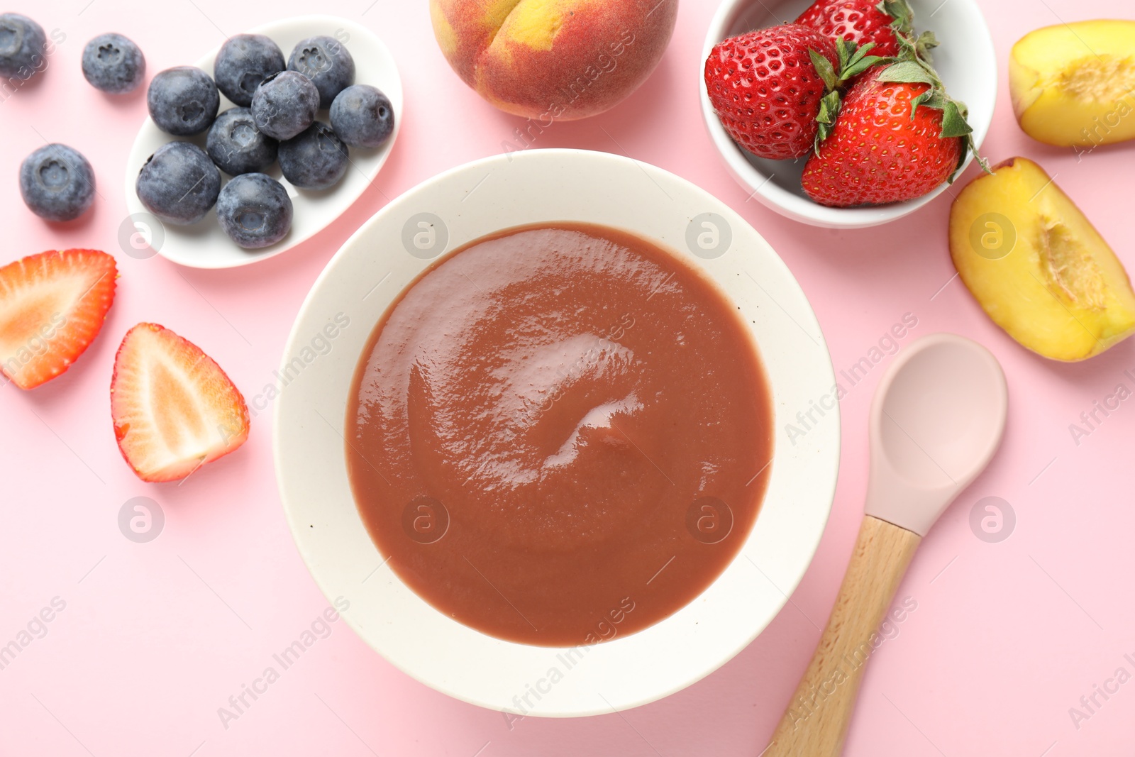 Baby food. Tasty puree in bowl and ingredients on pink background, flat lay Photo of Baby food. Tasty puree in bowl and ingredients on pink background, flat lay