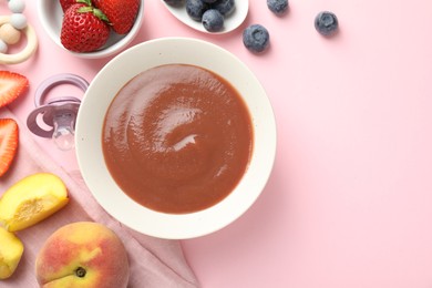Photo of Baby food. Tasty puree in bowl, pacifier, teether and ingredients on pink background, flat lay. Space for text