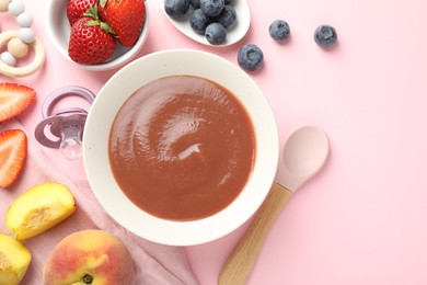 Photo of Baby food. Tasty puree in bowl, pacifier, teether and ingredients on pink background, flat lay