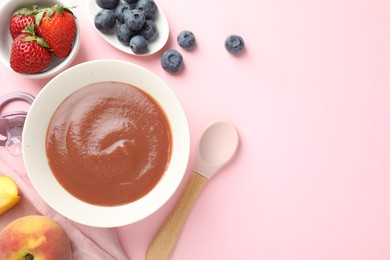 Photo of Baby food. Tasty puree in bowl, pacifier and ingredients on pink background, flat lay. Space for text