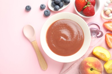 Photo of Baby food. Tasty puree in bowl, pacifier, teether and ingredients on pink background, flat lay