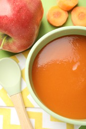 Photo of Baby food. Tasty puree in bowl and ingredients on green background, flat lay