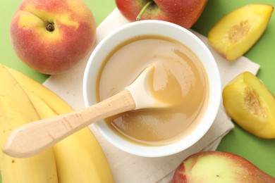Photo of Baby food. Tasty puree in bowl and ingredients on green background, flat lay