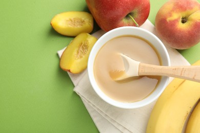 Photo of Baby food. Tasty puree in bowl and ingredients on green background, flat lay. Space for text