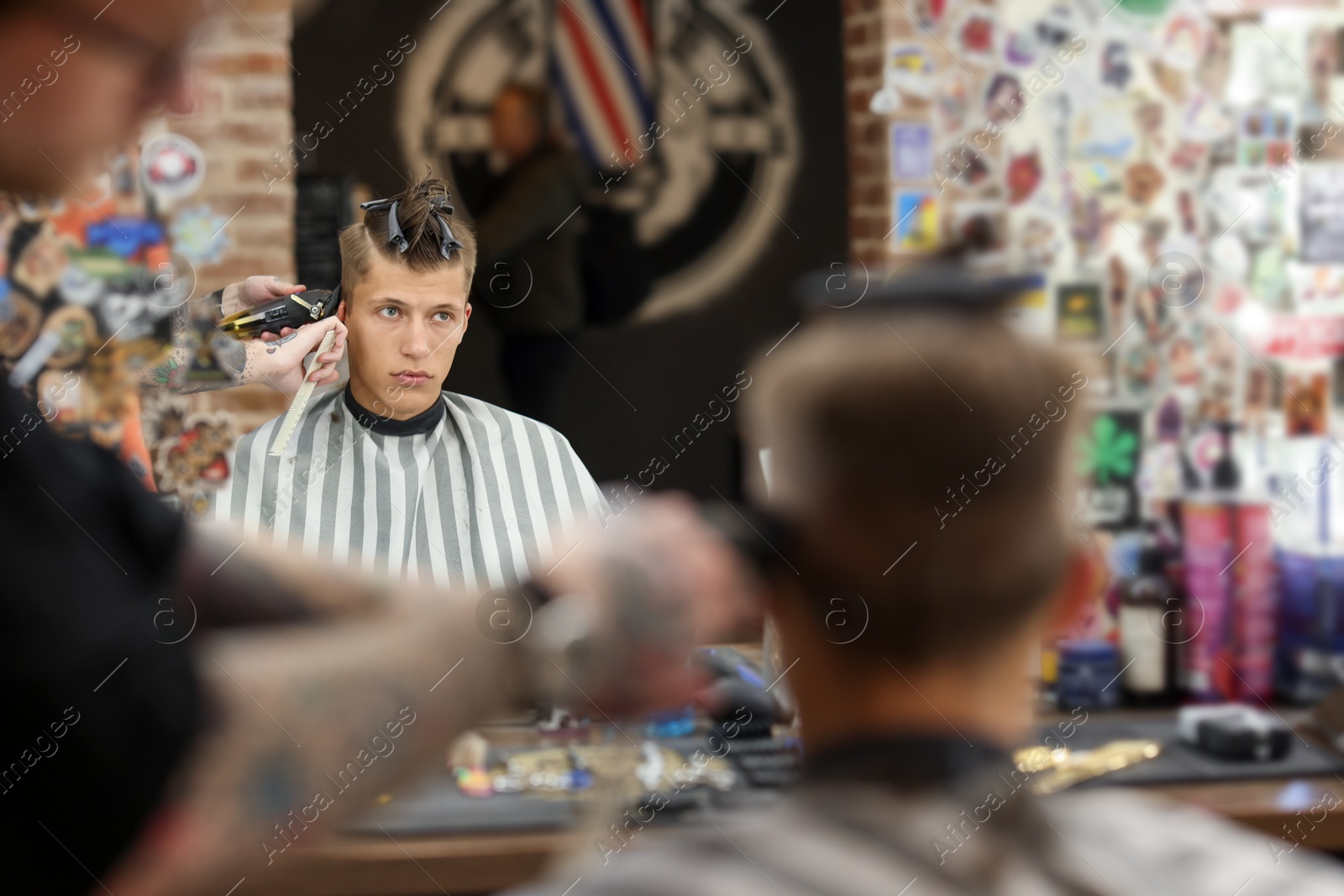 Professional barber making stylish haircut in barbershop, closeup Photo of Professional barber making stylish haircut in barbershop, closeup