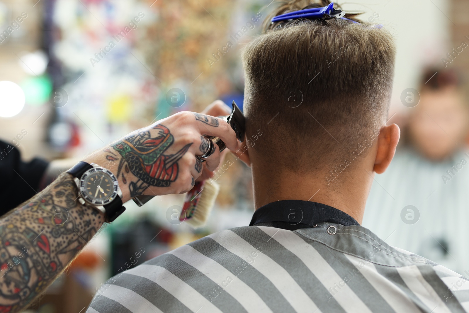 Professional barber making stylish haircut in barbershop, closeup Photo of Professional barber making stylish haircut in barbershop, closeup