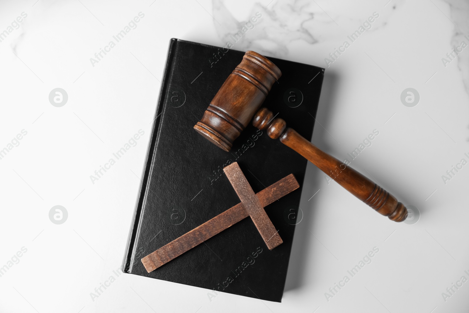 Judge's gavel, Bible and wooden cross on white marble table, top view Photo of Judge's gavel, Bible and wooden cross on white marble table, top view