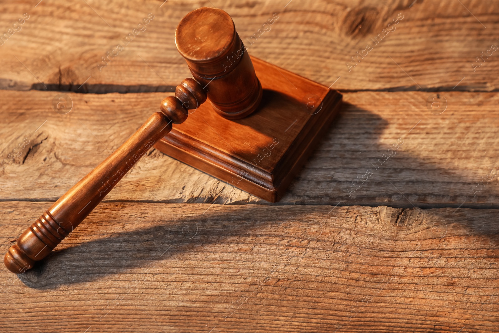 Judge's gavel on wooden table, above view. Space for text Photo of Judge's gavel on wooden table, above view. Space for text