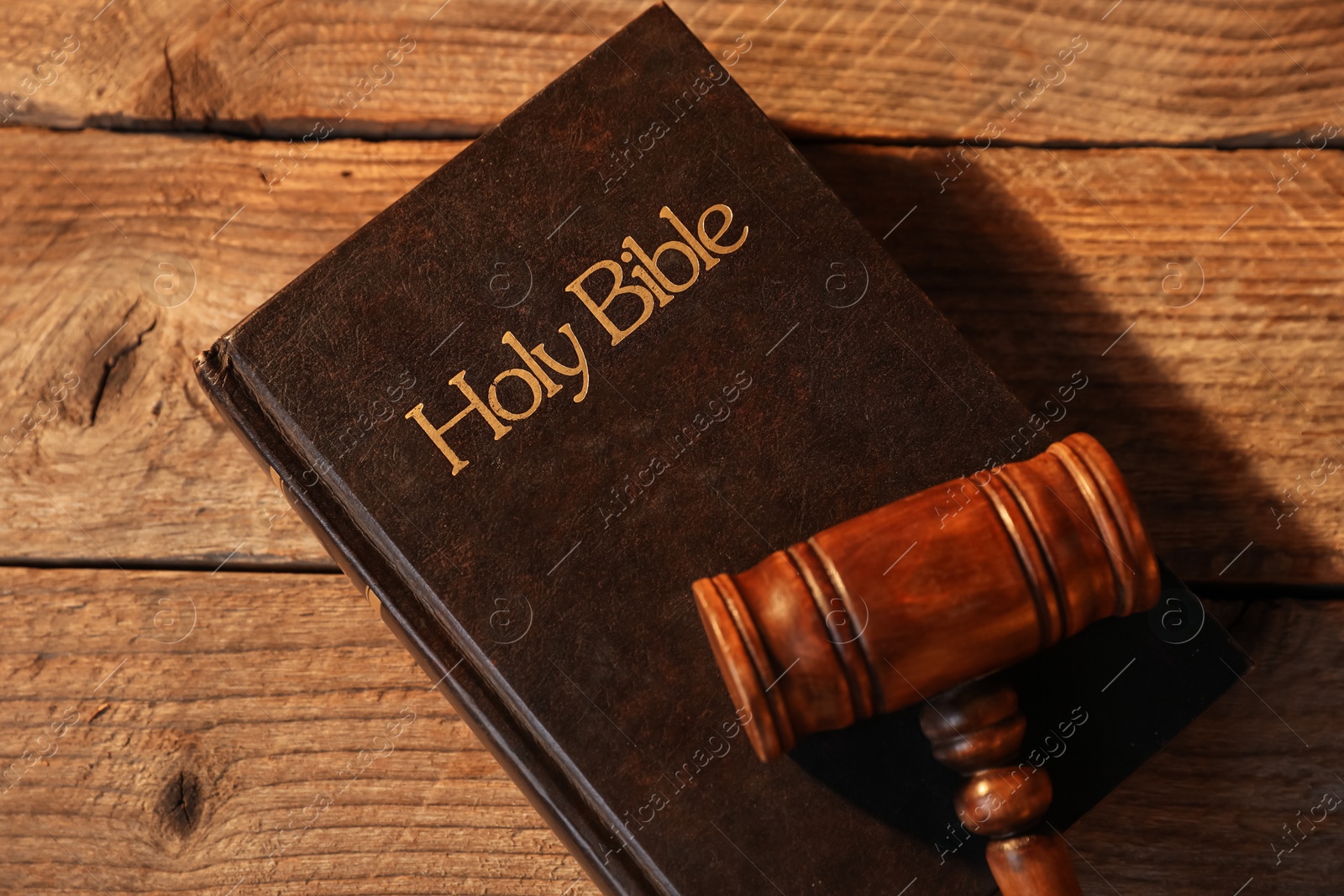 Judge's gavel and Bible on wooden table, top view Photo of Judge's gavel and Bible on wooden table, top view